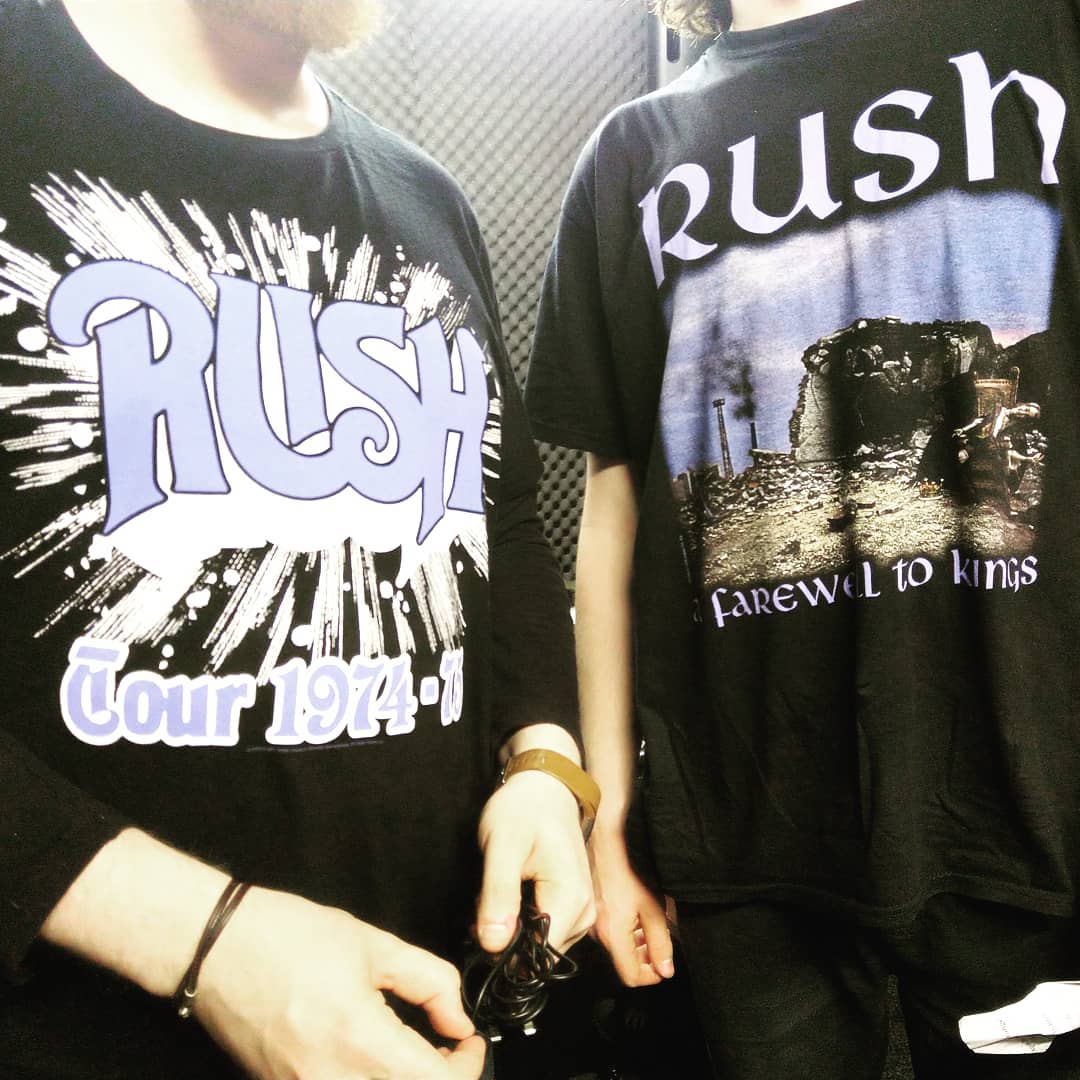 A close up of Paul and Christopher's Rush t-shirts