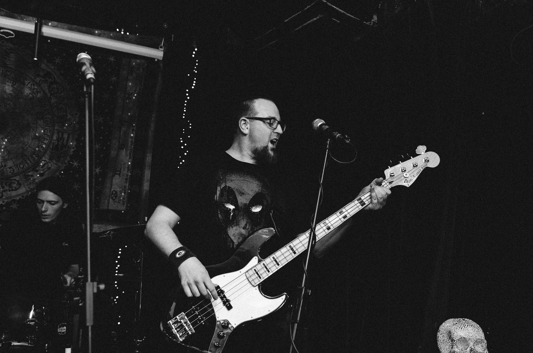 A black and white image of Christopher playing and singing along