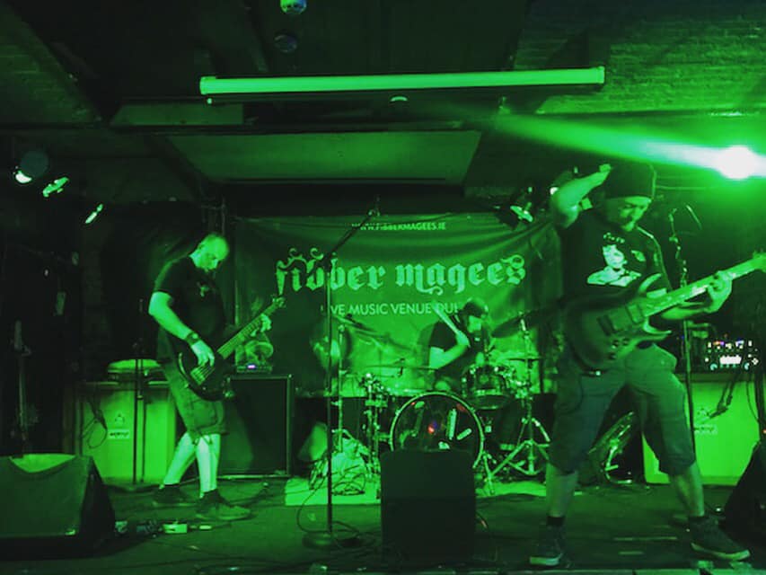 A green-tinted image of Ritual Effect live on stage
