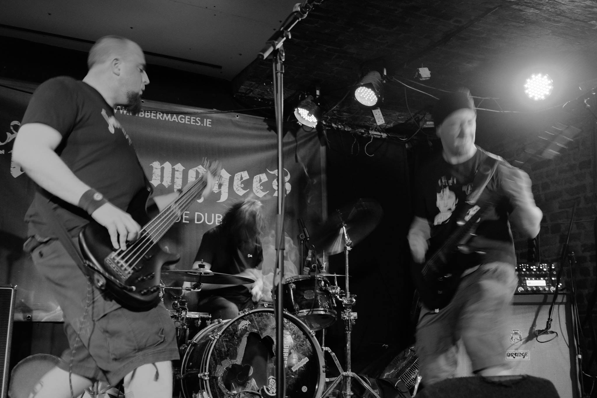 A black and white image of Ritual Effect in full flow live on stage