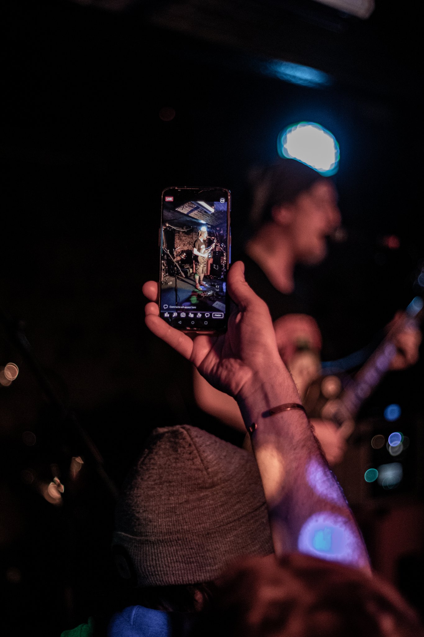A fan taking a picture of Ritual Effect on stage